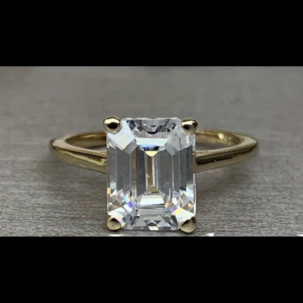 Stunning 14K gold emerald cut engagement ring.